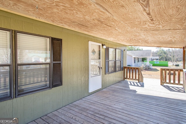 wooden terrace featuring covered porch