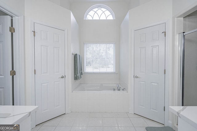 bathroom with tile patterned floors, plus walk in shower, and plenty of natural light