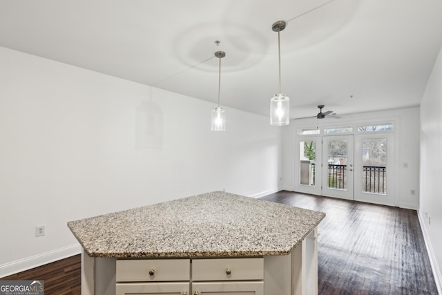 840 United Ave SE Unit 411, Atlanta, GA 30312 - kitchen featuring hanging light fixtures, light stone countertops, dark hardwood / wood-style floors, and ceiling fan