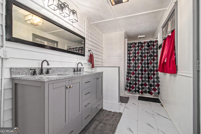 full bath featuring curtained shower, marble finish floor, a sink, and double vanity