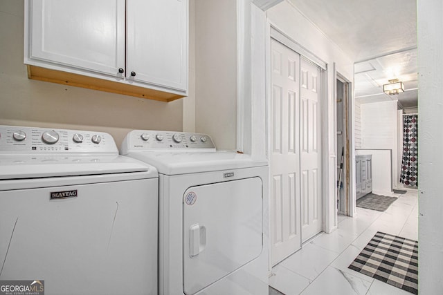 laundry area featuring marble finish floor, cabinet space, and independent washer and dryer