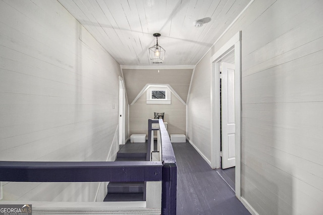 stairs with wooden walls and wood finished floors