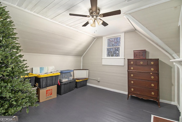 additional living space featuring dark wood-style floors, vaulted ceiling, baseboards, and ceiling fan