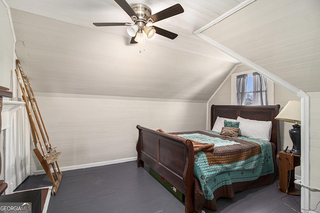 bedroom featuring a ceiling fan, lofted ceiling, baseboards, and wood finished floors