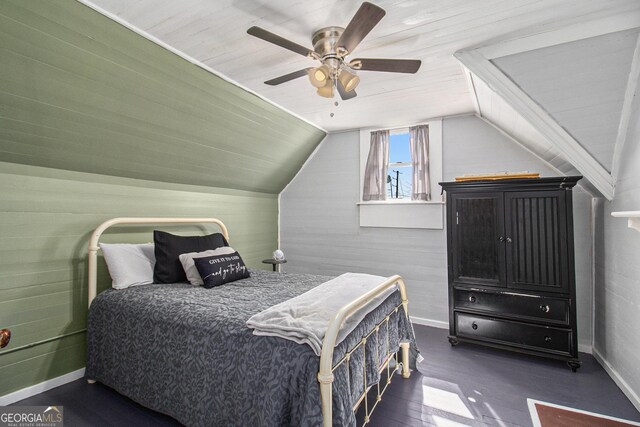 bedroom with vaulted ceiling, dark wood finished floors, a ceiling fan, and baseboards