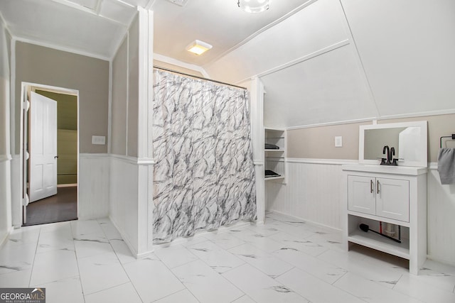 bathroom featuring marble finish floor, a wainscoted wall, and vanity