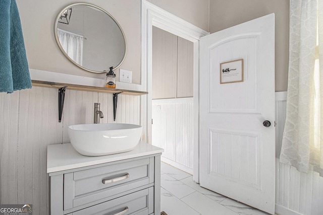 bathroom featuring marble finish floor and vanity