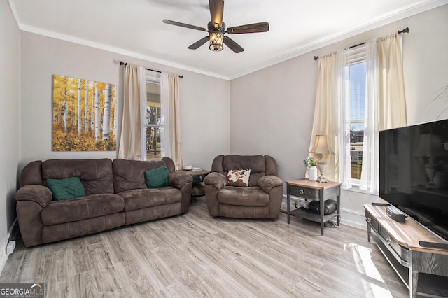 living area with light wood-style floors, crown molding, and a ceiling fan