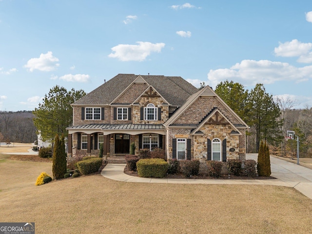 craftsman house with a porch and a front lawn