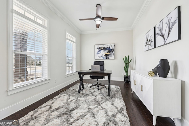 office area with dark wood-type flooring, ornamental molding, and ceiling fan