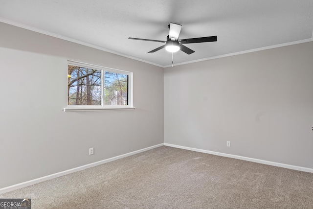 carpeted empty room with crown molding and ceiling fan