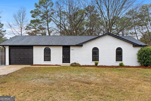 ranch-style house with concrete driveway, a front lawn, an attached garage, and brick siding