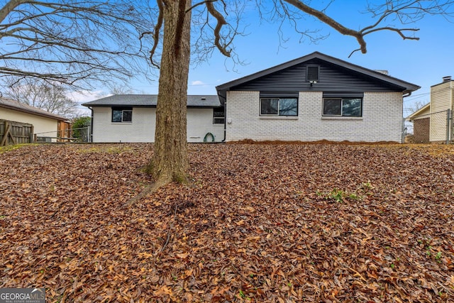 exterior space with brick siding and fence
