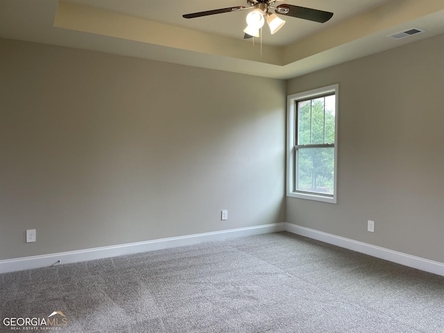 unfurnished living room featuring visible vents, a premium fireplace, baseboards, and wood finished floors