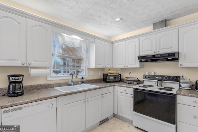 kitchen with a textured ceiling, under cabinet range hood, white appliances, a sink, and white cabinets