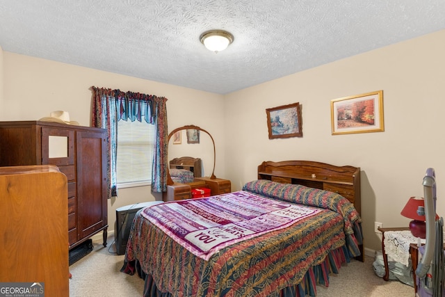 bedroom featuring light carpet, a textured ceiling, and baseboards