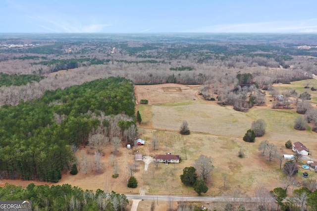 drone / aerial view featuring a rural view and a view of trees