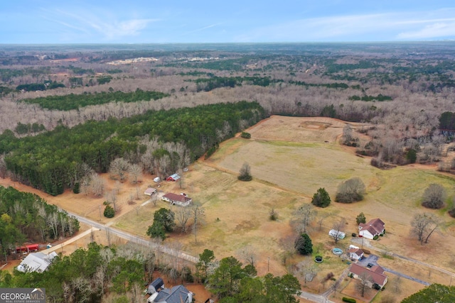 aerial view featuring a rural view and a wooded view