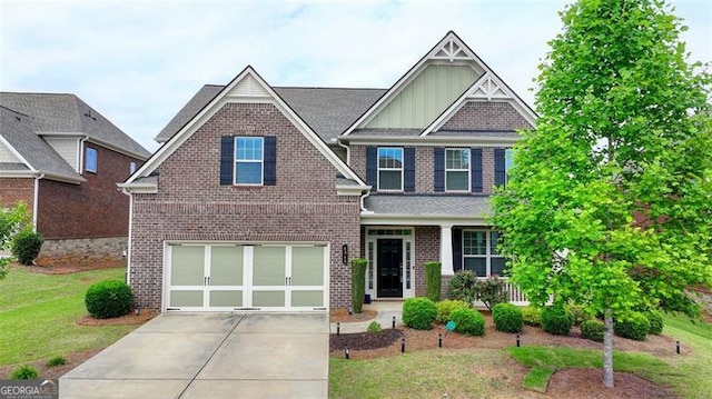 craftsman house with a garage, covered porch, and a front yard