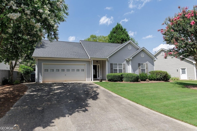 ranch-style house featuring a garage and a front yard