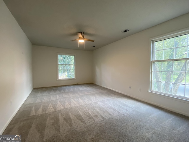 spare room with light carpet and ceiling fan