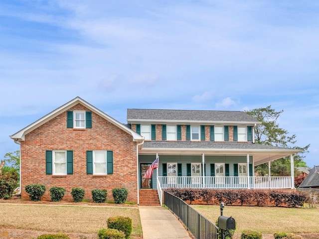 view of front of house with a front yard and covered porch