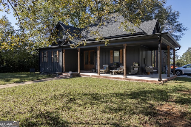 rear view of house with a yard and a patio