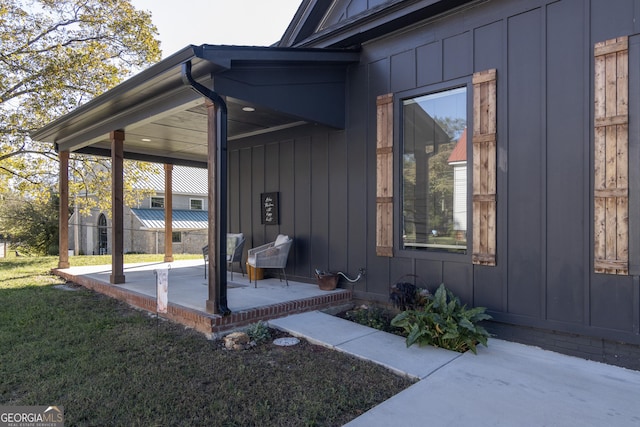 entrance to property featuring a yard and a patio