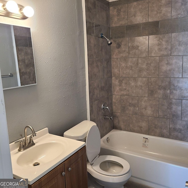 full bathroom featuring vanity, toilet, and tiled shower / bath