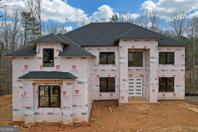 property in mid-construction featuring a shingled roof