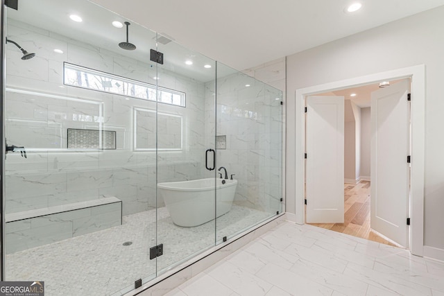 bathroom with separate shower and tub