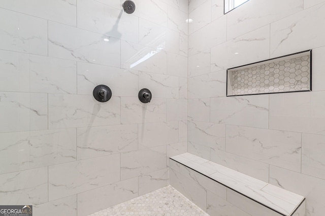 bathroom with tiled shower