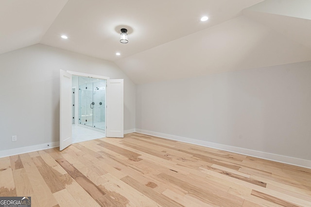 bonus room featuring vaulted ceiling and light wood-type flooring