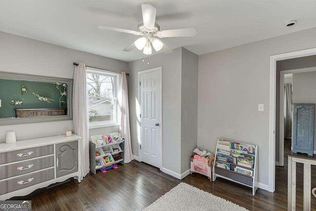 recreation room with dark hardwood / wood-style flooring and ceiling fan