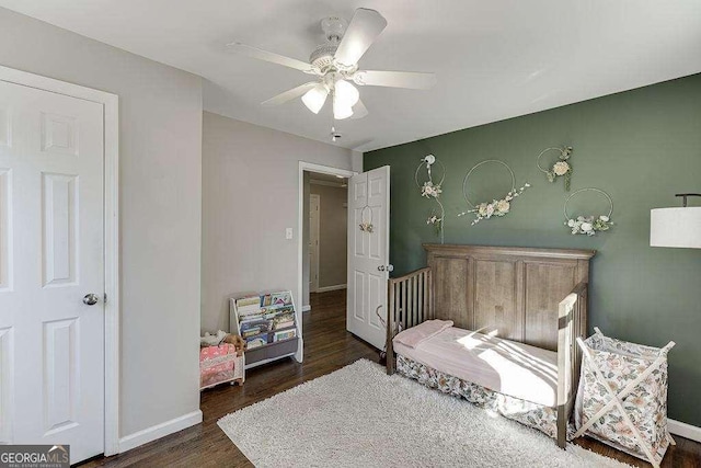 bedroom with dark hardwood / wood-style floors and ceiling fan