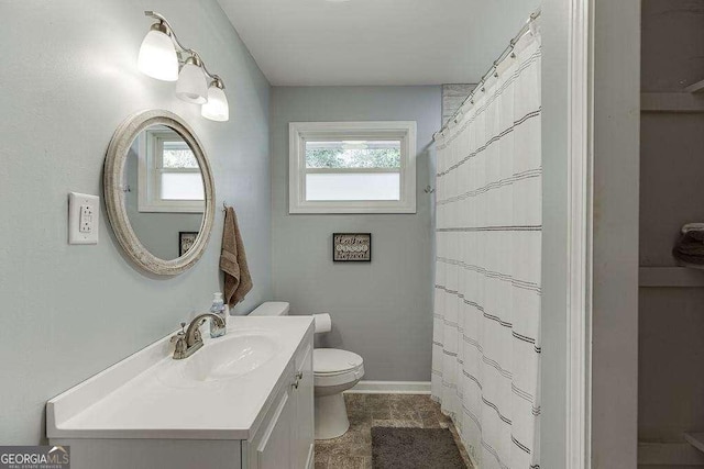 bathroom with vanity, walk in shower, and toilet