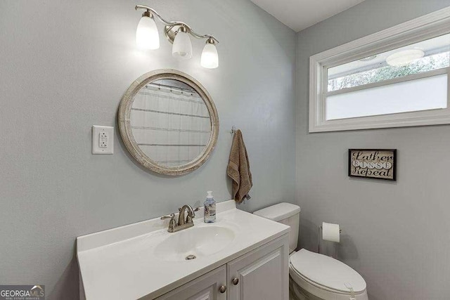 bathroom featuring vanity and toilet