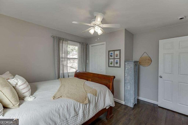 bedroom with ceiling fan, dark hardwood / wood-style flooring, and a closet