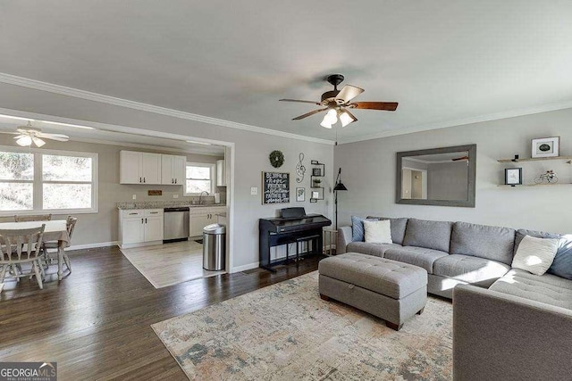 living room with crown molding, sink, hardwood / wood-style floors, and ceiling fan