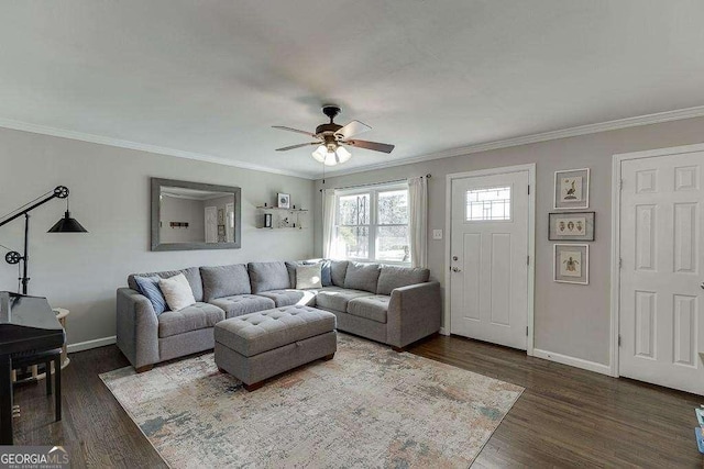 living room with ornamental molding, dark wood-type flooring, and ceiling fan