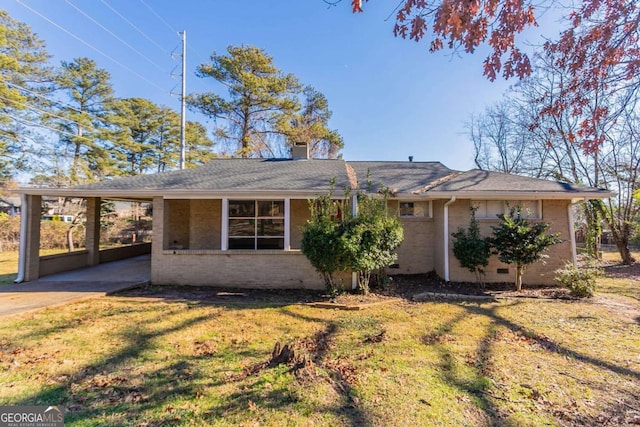 ranch-style house with a carport and a front lawn