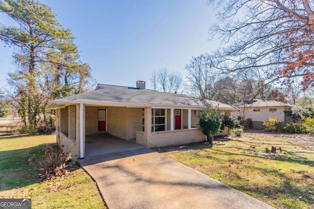 ranch-style house featuring a carport and a front lawn