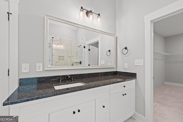 bathroom with a shower with door and vanity