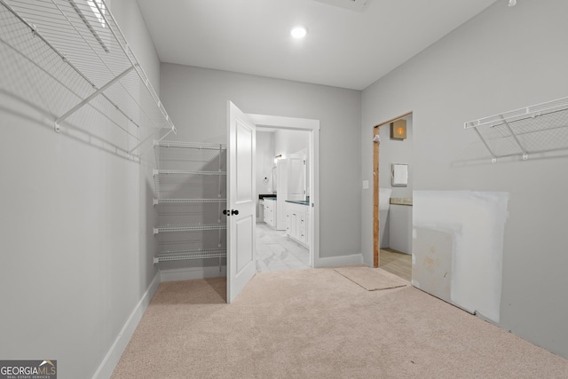 spacious closet with light colored carpet