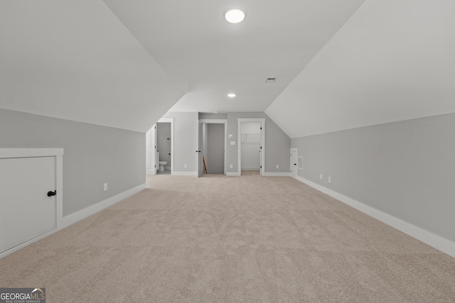 additional living space with lofted ceiling and light colored carpet