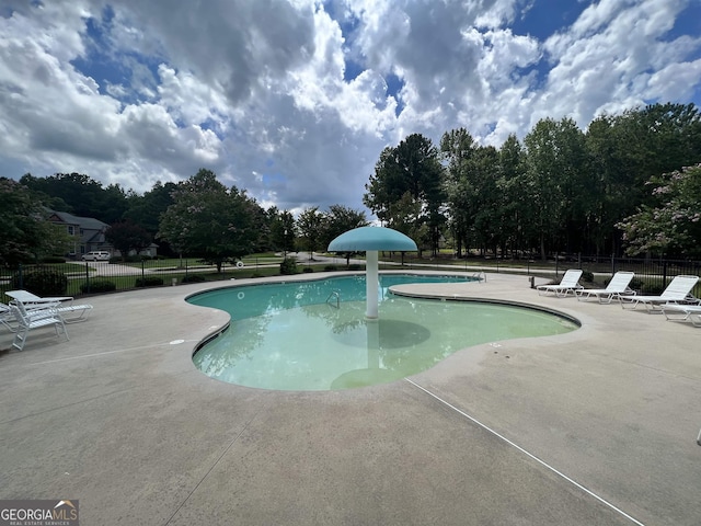 view of swimming pool with a patio area