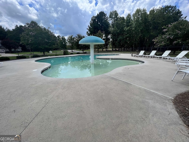 view of swimming pool with a patio