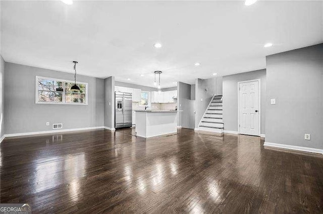 unfurnished living room featuring dark hardwood / wood-style floors