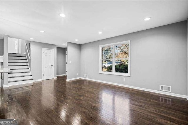 unfurnished living room featuring hardwood / wood-style flooring