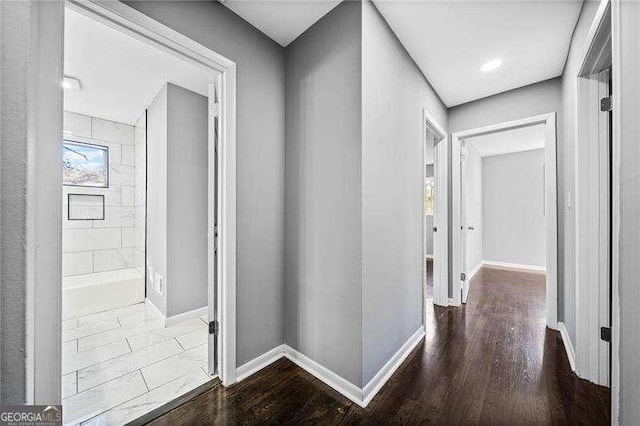 corridor featuring hardwood / wood-style floors